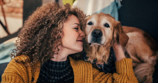 Woman cuddling with her dog